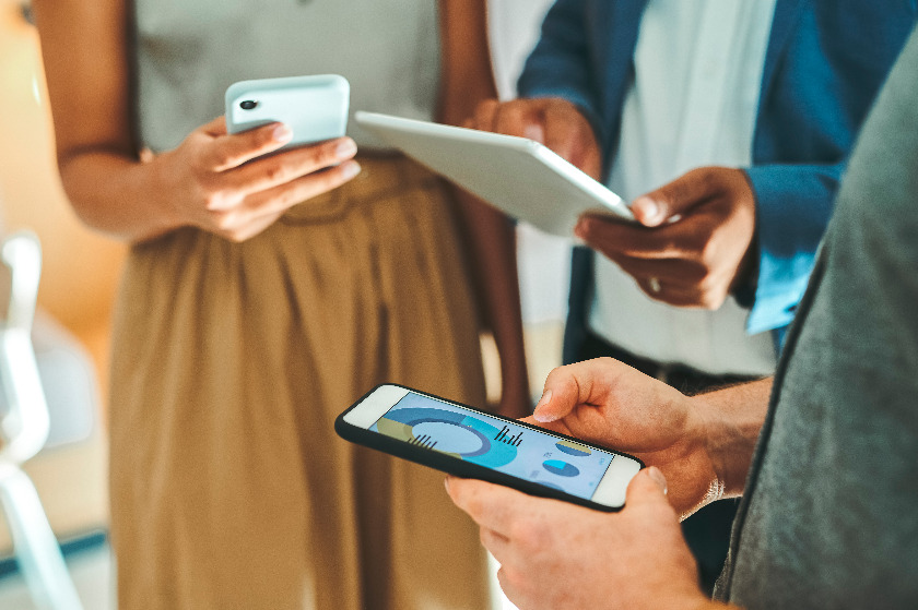 three people in a semi circle on various devices three people in a semi circle on various devices